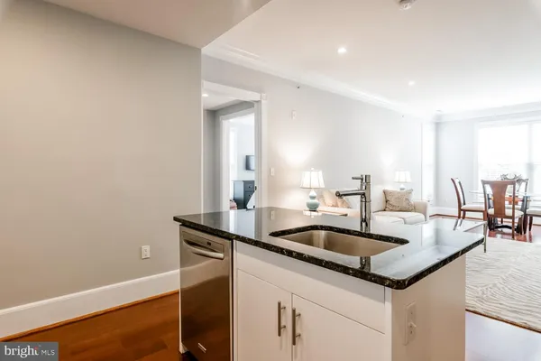 a kitchen with granite countertop a sink and cabinets