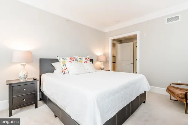 a bedroom with a bed and a lamp