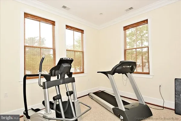 a view of a patio with couches table and chairs and potted plants