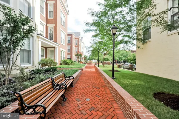 a view of an apartment with a garden and pathway
