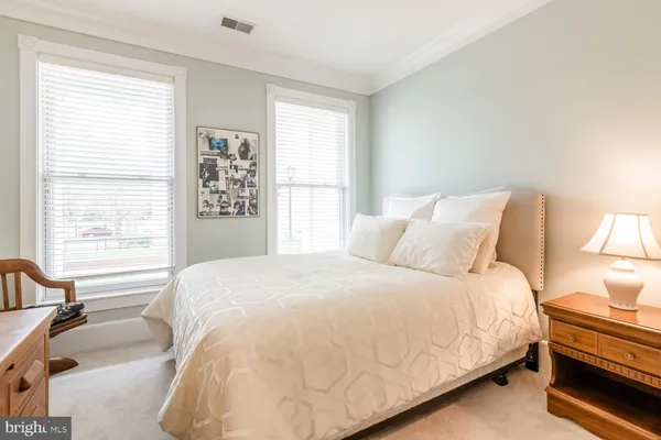 a bedroom with a bed and a large window