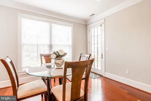 a view of a dining room with furniture and wooden floor