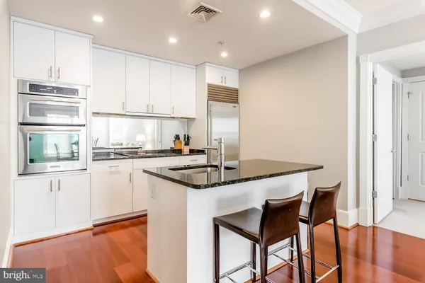a kitchen with stainless steel appliances granite countertop a stove refrigerator sink and cabinets