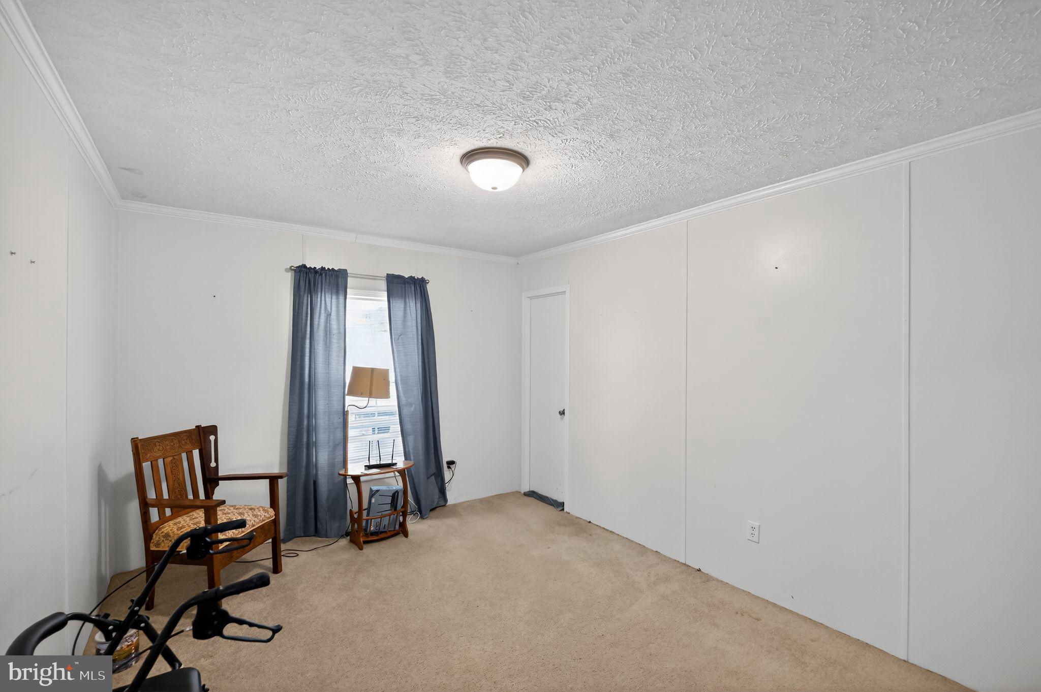 178 Lizzie Mills Road Castleton, VA 22716 - Photo 22 of 40 a view of a room with gym equipment and a window