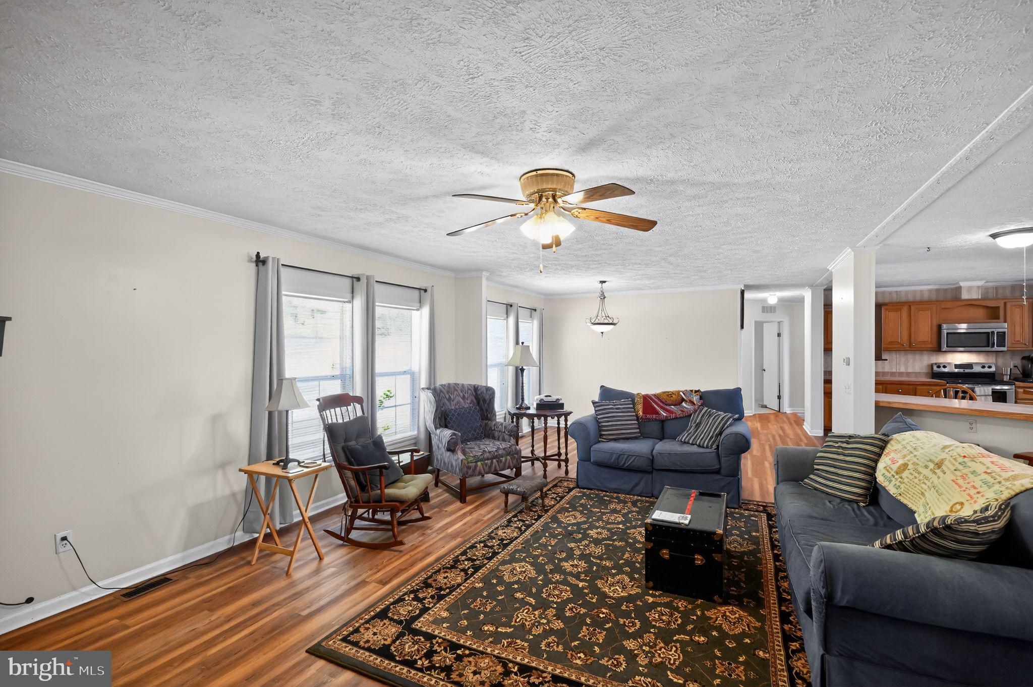 178 Lizzie Mills Road Castleton, VA 22716 - Photo 23 of 40 a living room with furniture and a chandelier