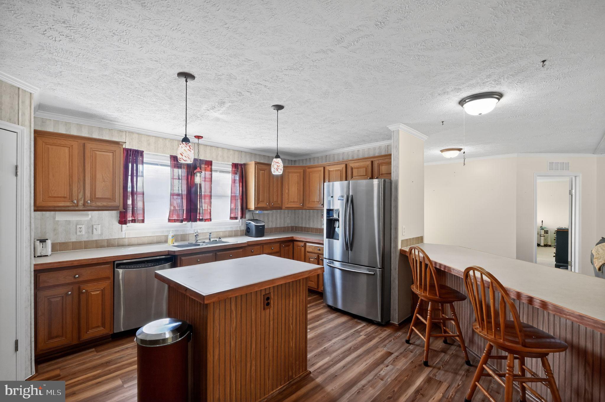 178 Lizzie Mills Road Castleton, VA 22716 - Photo 27 of 40 a kitchen with stainless steel appliances a sink a kitchen island a stove a refrigerator and a center island