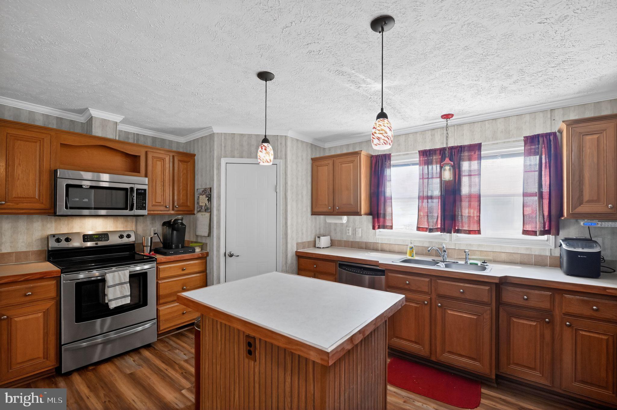 178 Lizzie Mills Road Castleton, VA 22716 - Photo 28 of 40 a kitchen with stainless steel appliances granite countertop a sink a stove and a wooden floors