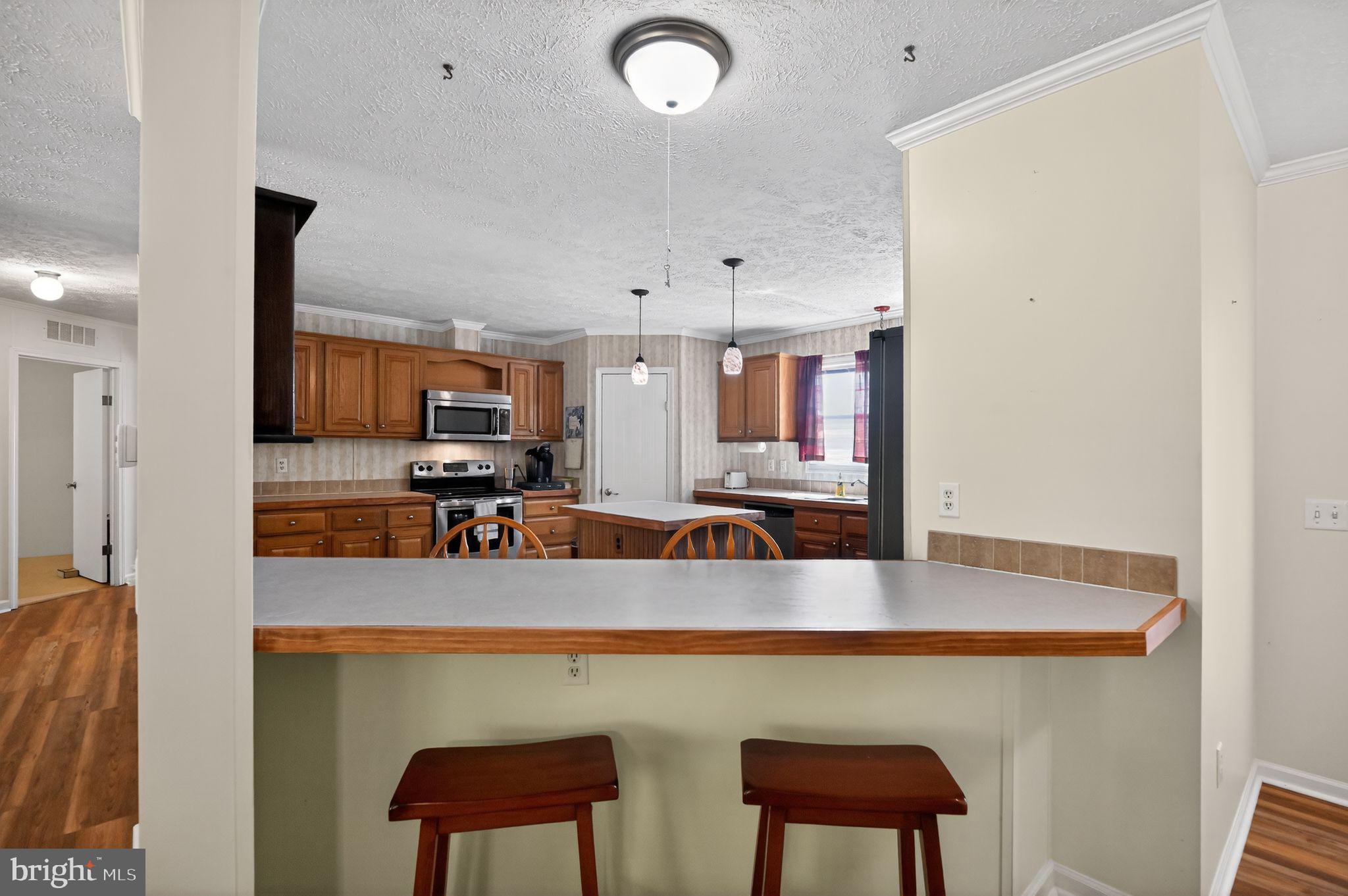178 Lizzie Mills Road Castleton, VA 22716 - Photo 29 of 40 a kitchen with a dining table chairs and a refrigerator