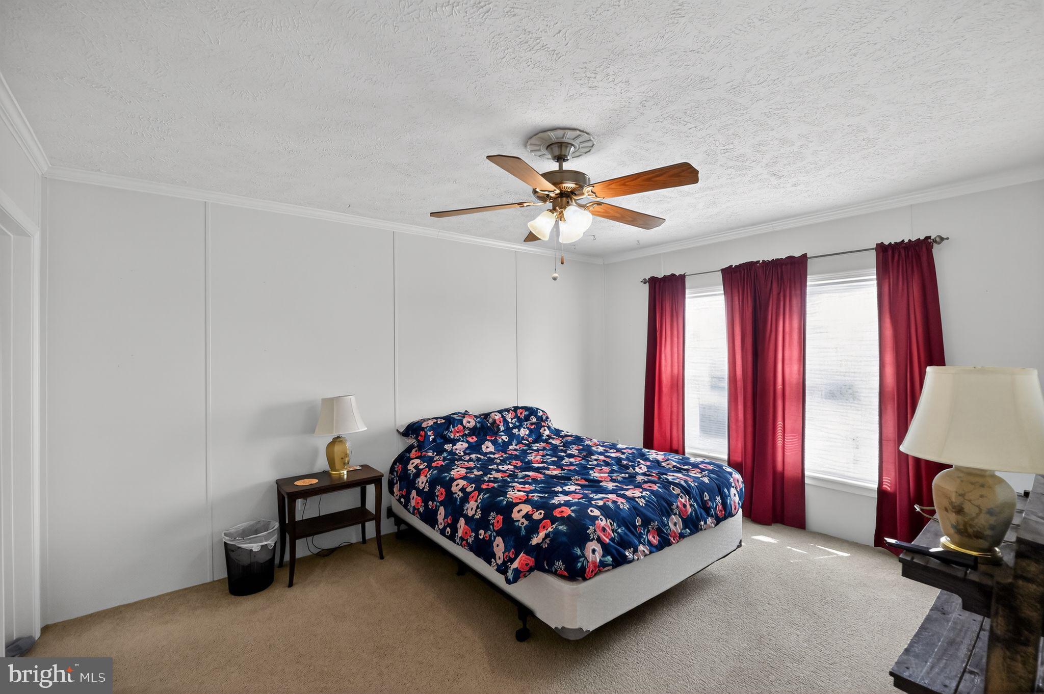 178 Lizzie Mills Road Castleton, VA 22716 - Photo 33 of 40 a bedroom with a bed and a chandelier