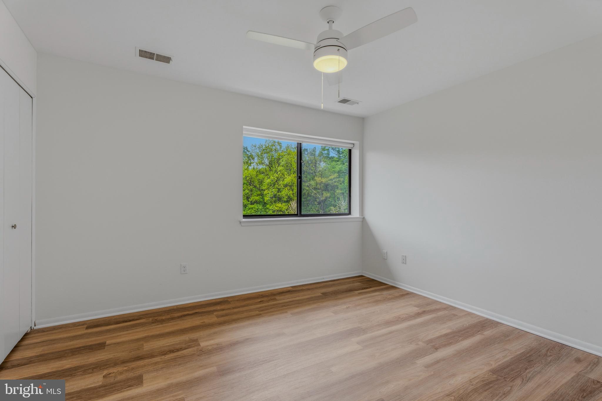 10604 Partridge Lane, Unit C3 Cockeysville, MD 21030 - Photo 11 of 23 an empty room with wooden floor and windows