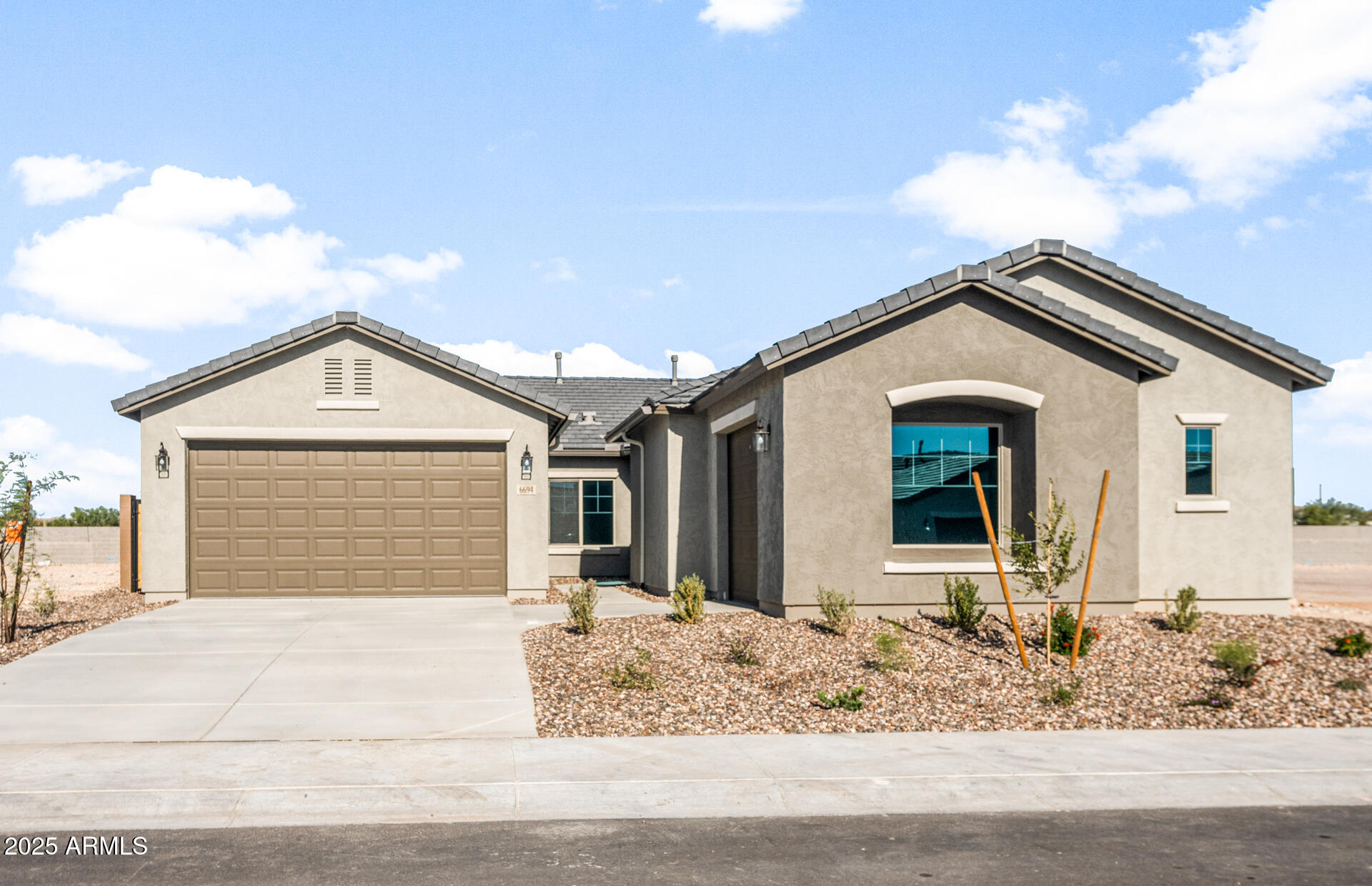 a view of house with garage and yard
