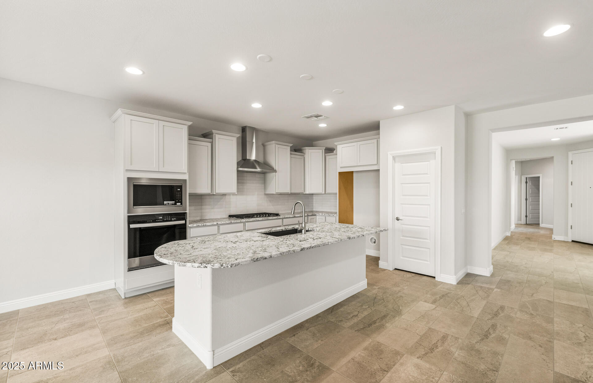 6694 West Ripken Way Florence, AZ 85132 - Photo 12 of 37 a large kitchen with stainless steel appliances granite countertop a stove a sink and a refrigerator