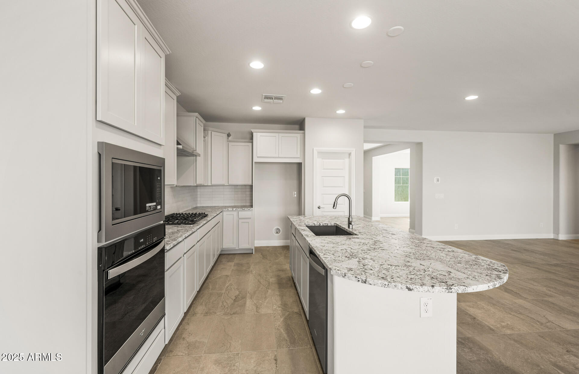 6694 West Ripken Way Florence, AZ 85132 - Photo 13 of 37 a large kitchen with granite countertop a large counter top stainless steel appliances and cabinets