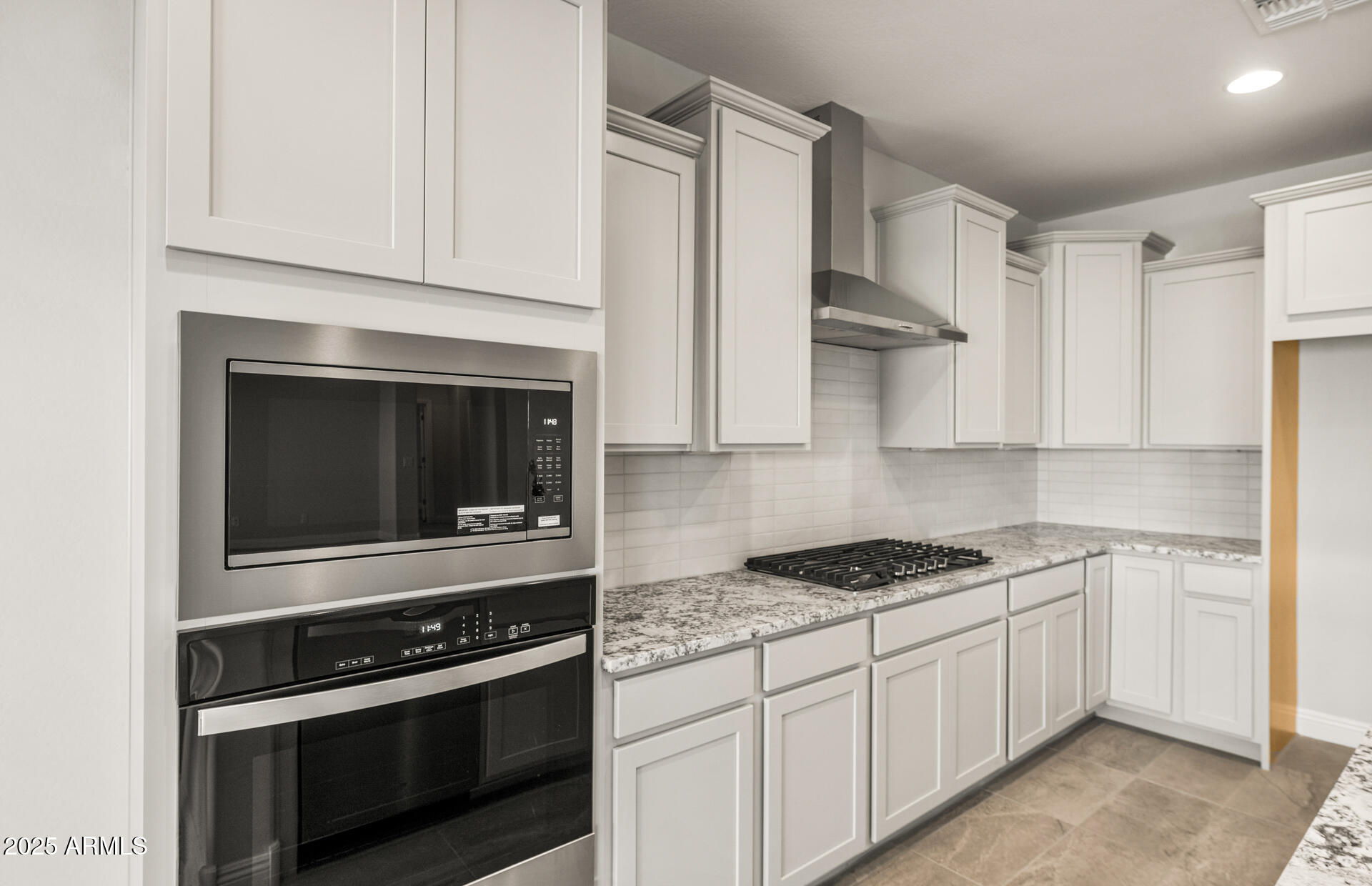 6694 West Ripken Way Florence, AZ 85132 - Photo 14 of 37 a kitchen with white cabinets and appliances