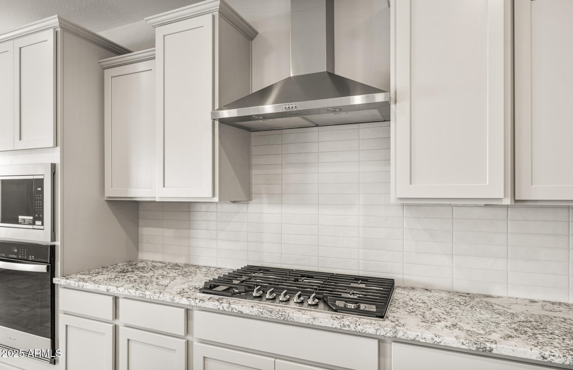 6694 West Ripken Way Florence, AZ 85132 - Photo 15 of 37 a kitchen with a stove and cabinets