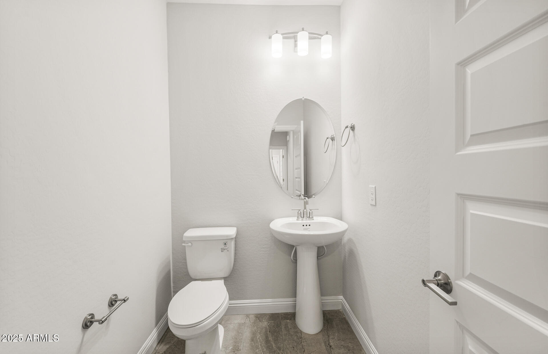 6694 West Ripken Way Florence, AZ 85132 - Photo 18 of 37 a bathroom with a toilet sink and mirror