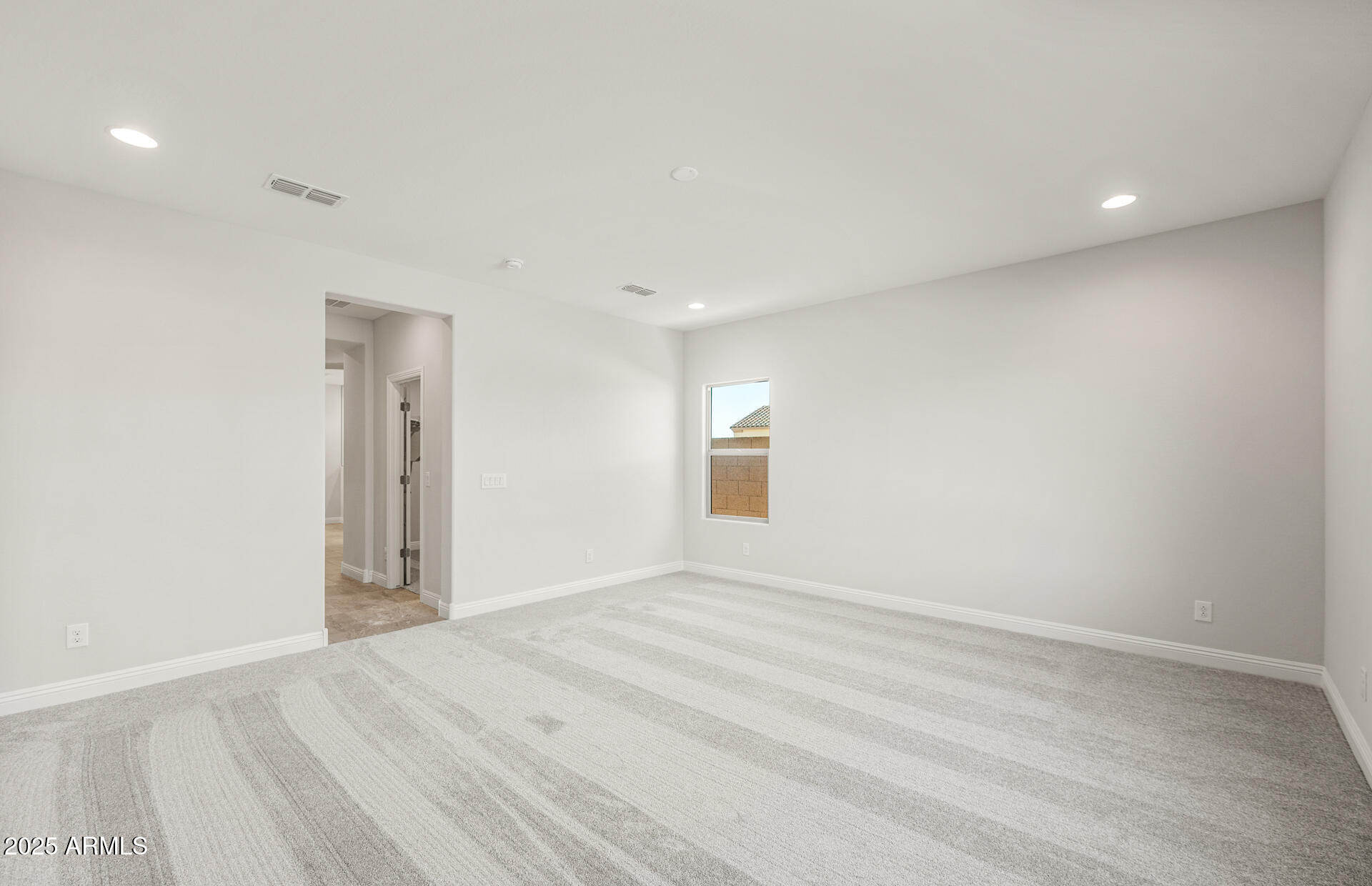 6694 West Ripken Way Florence, AZ 85132 - Photo 21 of 37 a view of an empty room with wooden floor and a window