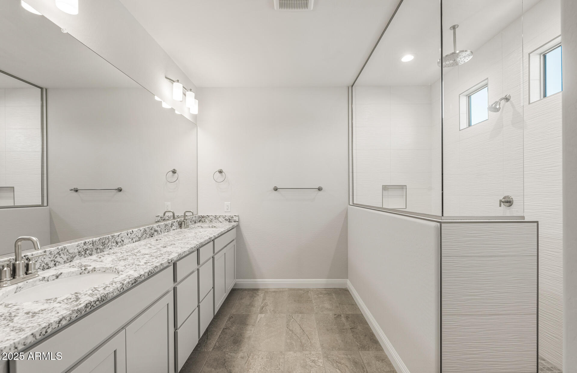 6694 West Ripken Way Florence, AZ 85132 - Photo 22 of 37 a bathroom with a granite countertop sink a mirror and a shower