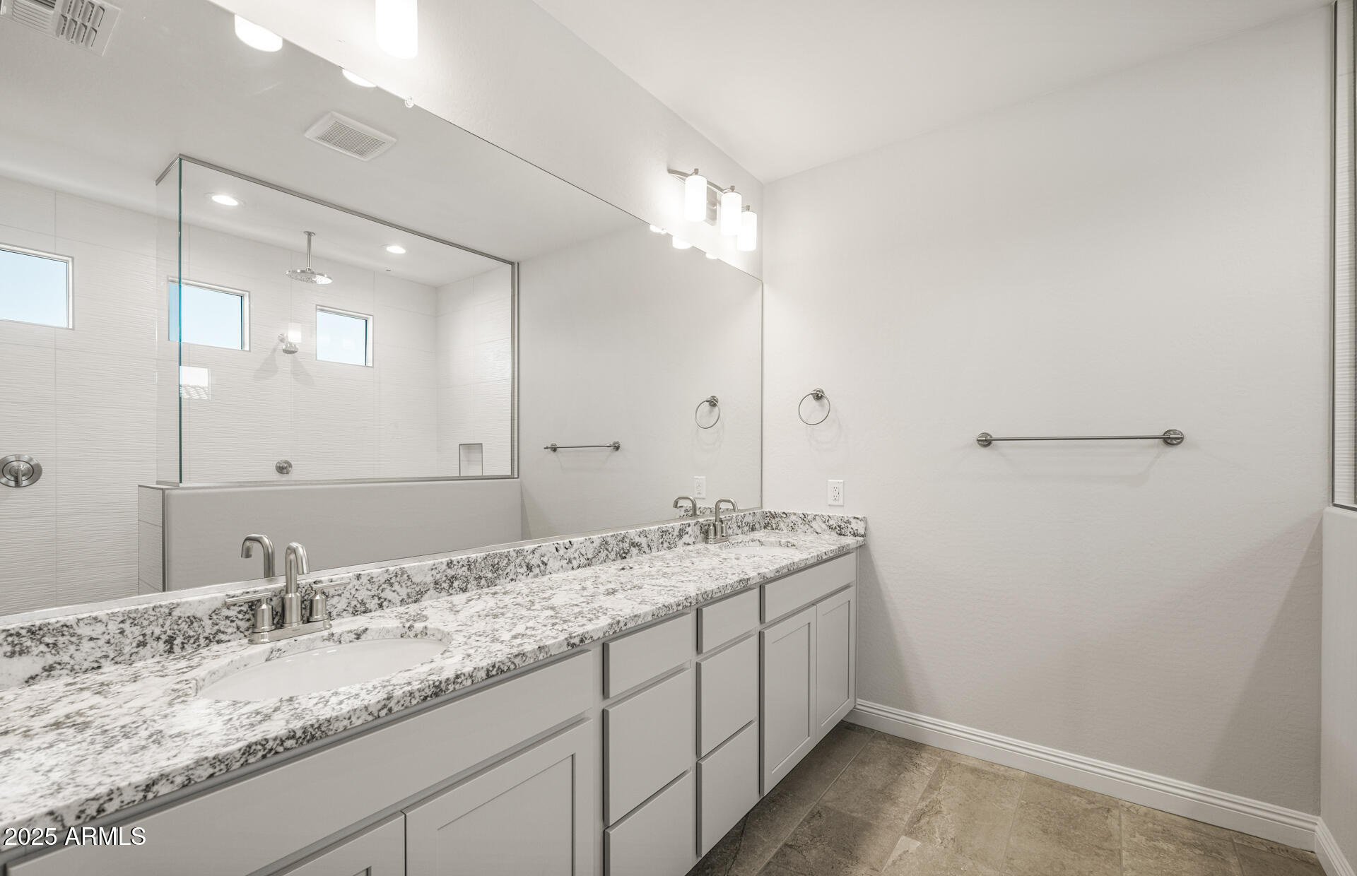 6694 West Ripken Way Florence, AZ 85132 - Photo 23 of 37 a bathroom with a granite countertop sink and a mirror