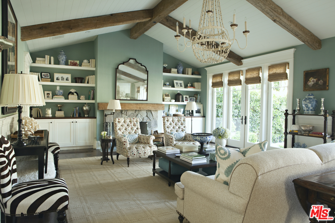 14100 Rustic Lane Pacific Palisades, CA 90272 - Photo 12 of 46 a living room with furniture a chandelier and a large window