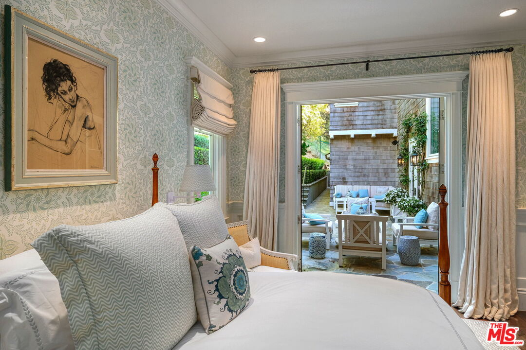 14100 Rustic Lane Pacific Palisades, CA 90272 - Photo 18 of 46 a bedroom with furniture and a window