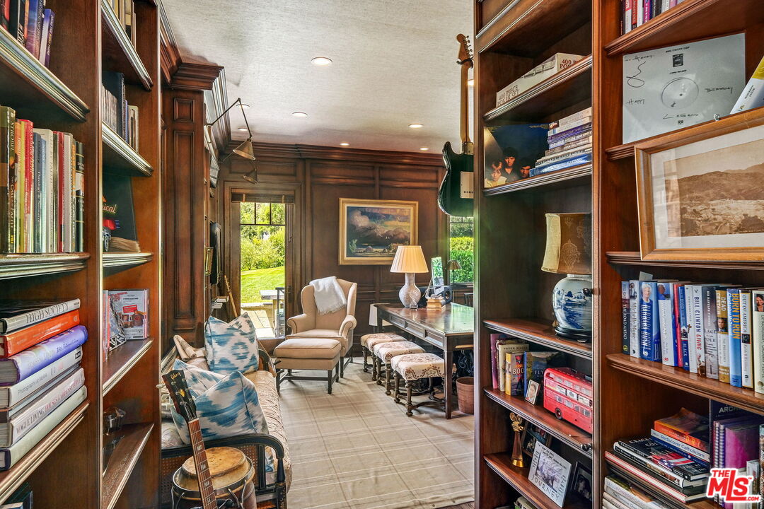 14100 Rustic Lane Pacific Palisades, CA 90272 - Photo 20 of 46 a living room with furniture and a book shelf