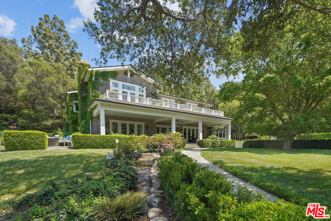 14100 Rustic Lane Pacific Palisades, CA 90272 - Photo 4 of 46 a front view of a house with a yard