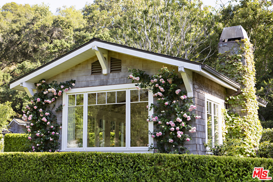 14100 Rustic Lane Pacific Palisades, CA 90272 - Photo 31 of 46 a front view of a house with garden