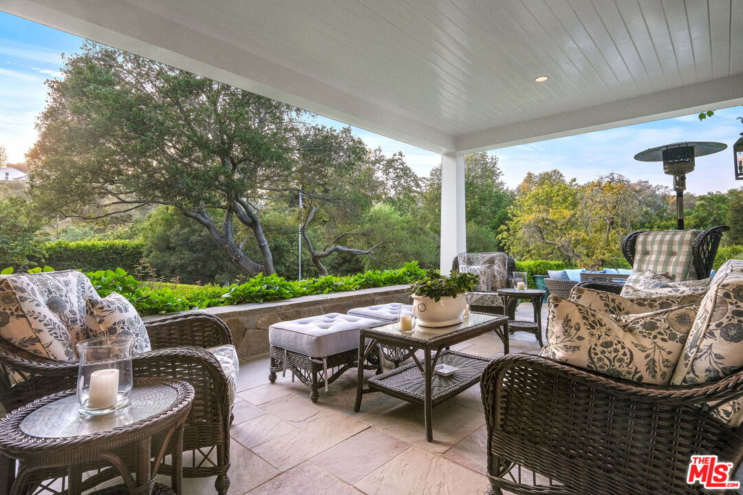 14100 Rustic Lane Pacific Palisades, CA 90272 - Photo 5 of 46 a view of a patio with couches potted plants and a big yard