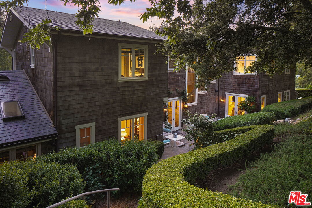 14100 Rustic Lane Pacific Palisades, CA 90272 - Photo 44 of 46 a view of a house with brick walls plants and large tree