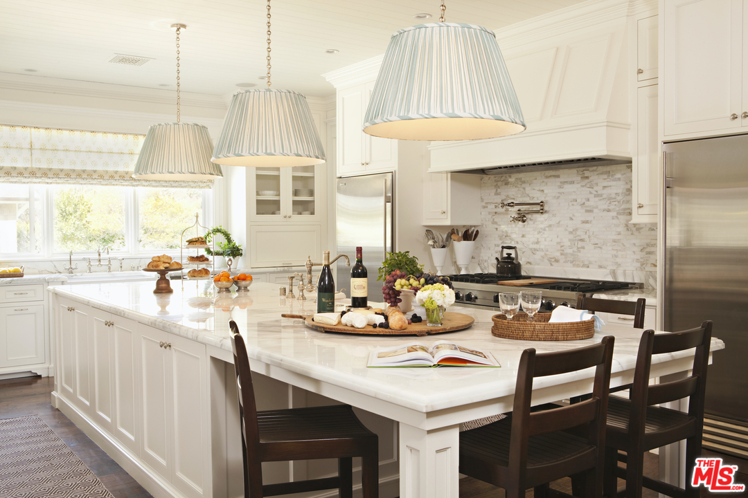 14100 Rustic Lane Pacific Palisades, CA 90272 - Photo 10 of 46 a kitchen with a sink a stove and white cabinets