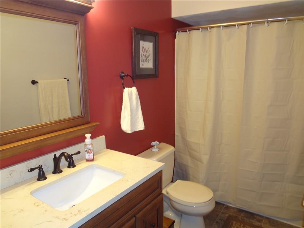 167 Town Country Road Vanderbilt, PA 15486 - Photo 12 of 25 Main Bathroom has been updated with Countertop, fixtures and more! Tub has Shower too with decorative stainless steel bowed shower rod for extra space.