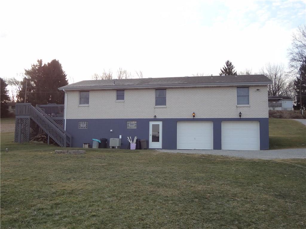 167 Town Country Road Vanderbilt, PA 15486 - Photo 22 of 25 Rear View of the Home with individual Garages, Man Door and Access to the Side Deck.