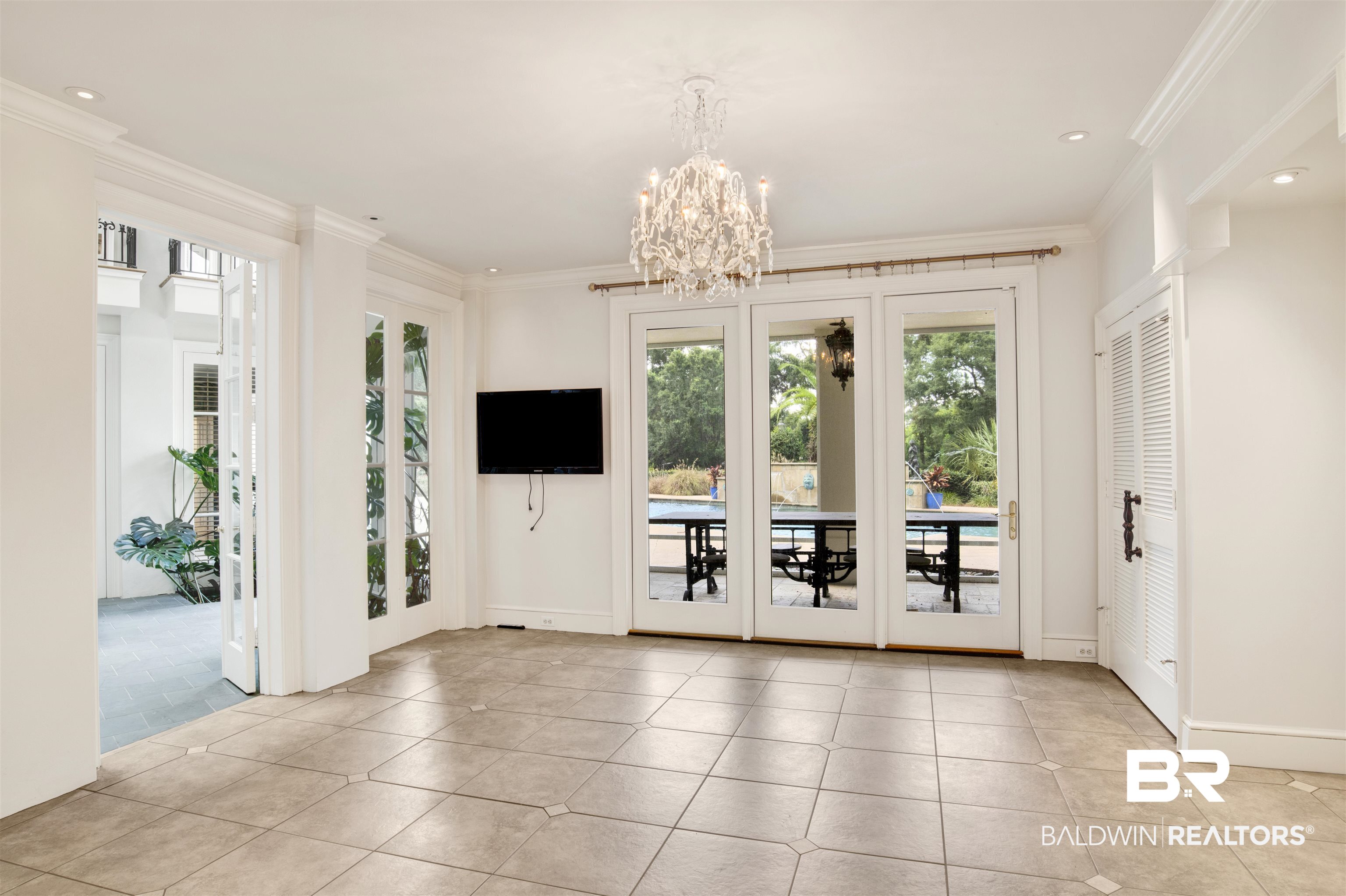 3816 Austill Lane Mobile, AL 36608 - Photo 52 of 80 Doorway to outside featuring ornamental molding, a chandelier, tile patterned floors, and recessed lighting