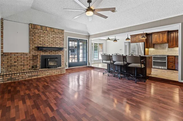 a kitchen with kitchen island a counter top space appliances and cabinets