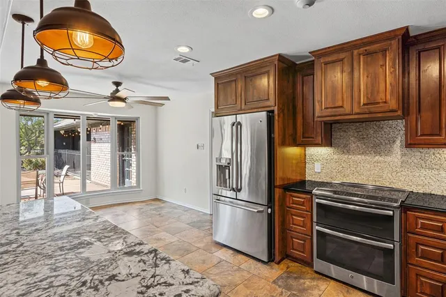 a hallway with a stove and a wooden floor