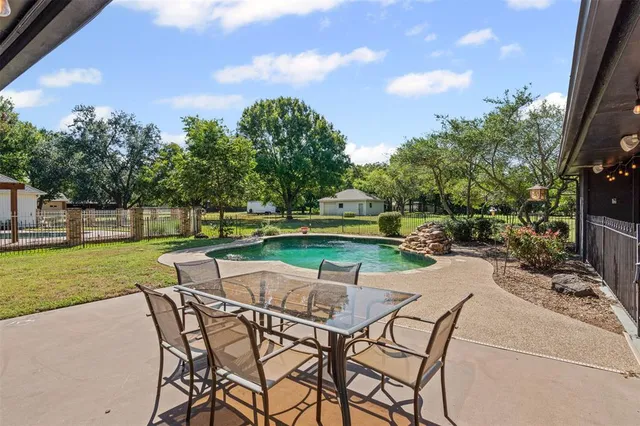 a view of a yard with furniture and garden