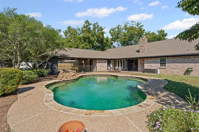 a view of a house with swimming pool and porch
