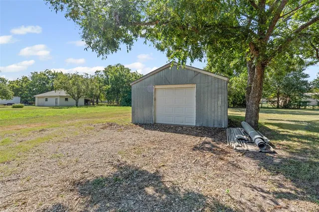 a backyard of a house with a yard and garage