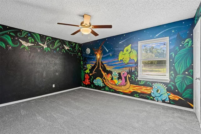 a view of a livingroom with a ceiling fan and window