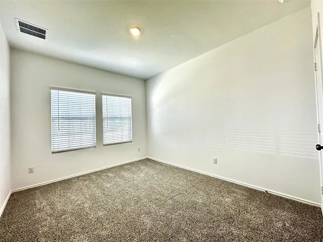 an empty room with a windows