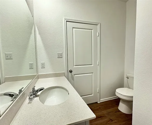 a bathroom with a sink a toilet and a mirror