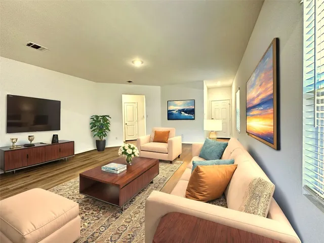 a living room with furniture and a flat screen tv