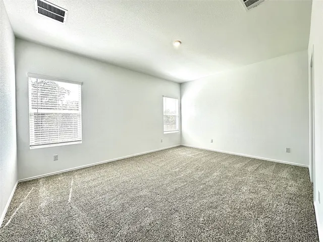 an empty room with a empty space and windows