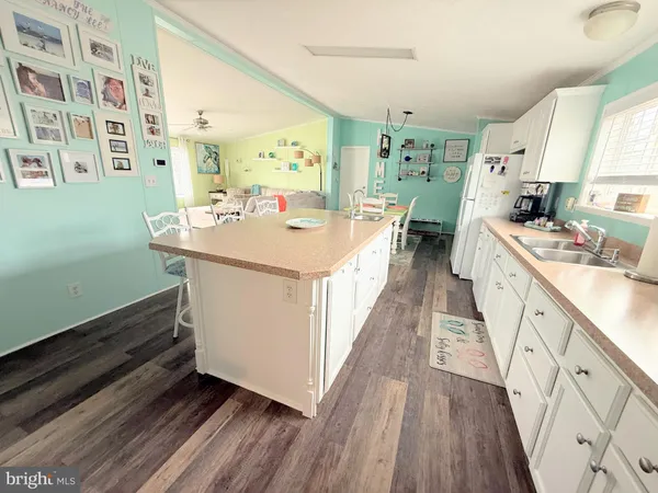 a kitchen with counter top space and wooden floor