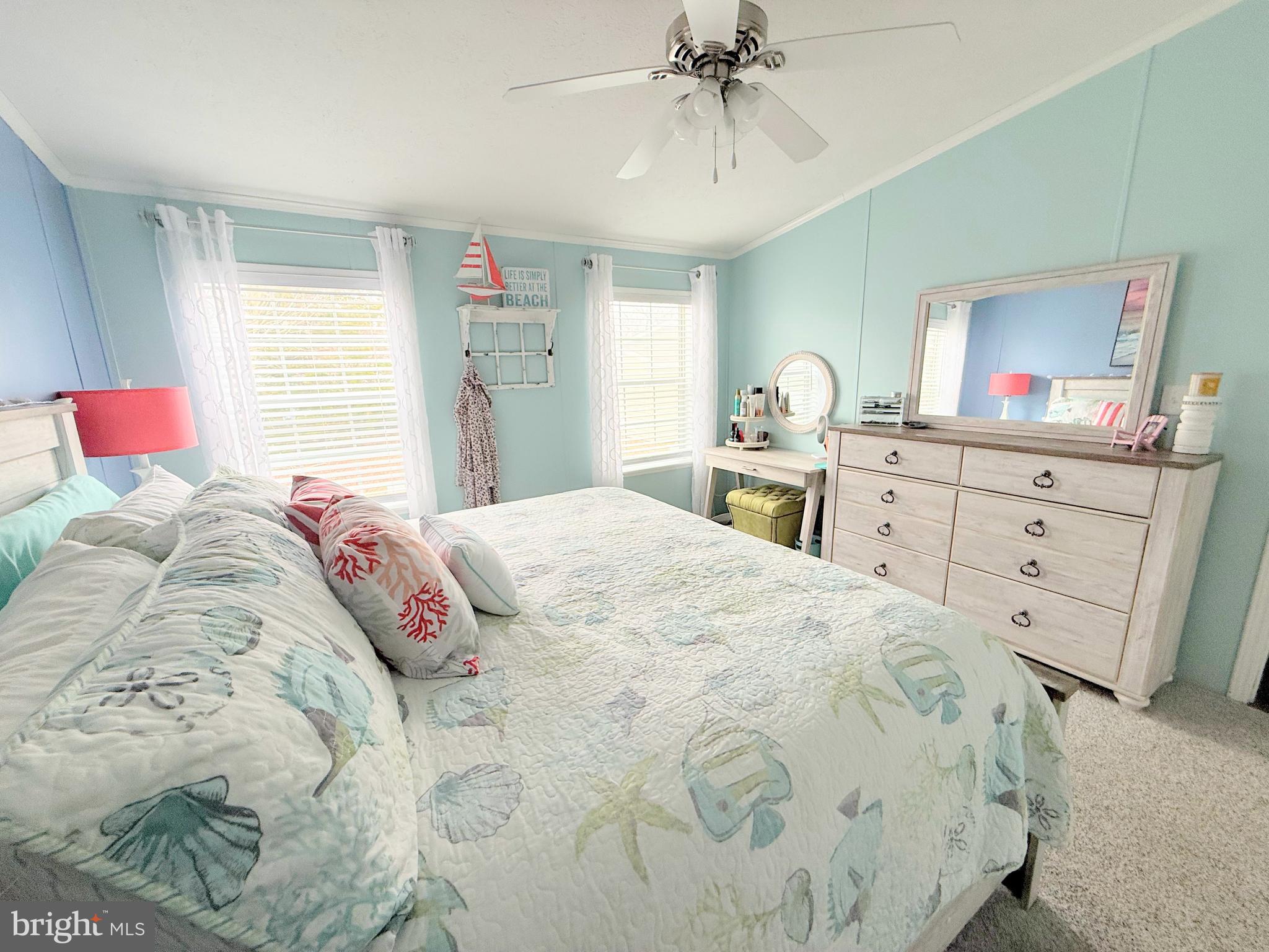34488 Easy Street, Unit E810 Long Neck, DE 19966 - Photo 20 of 55 a bedroom with a large bed and a chandelier