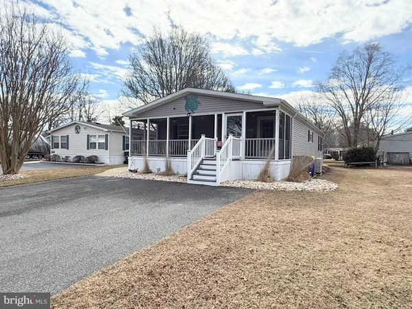 a view of a house with a yard covered in snow