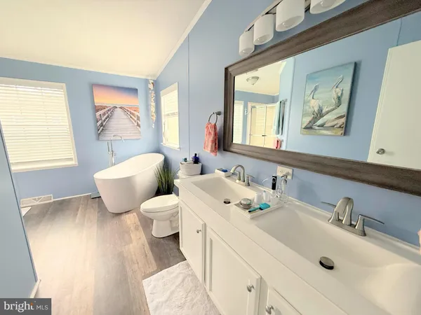 a living room with a white furniture and a window