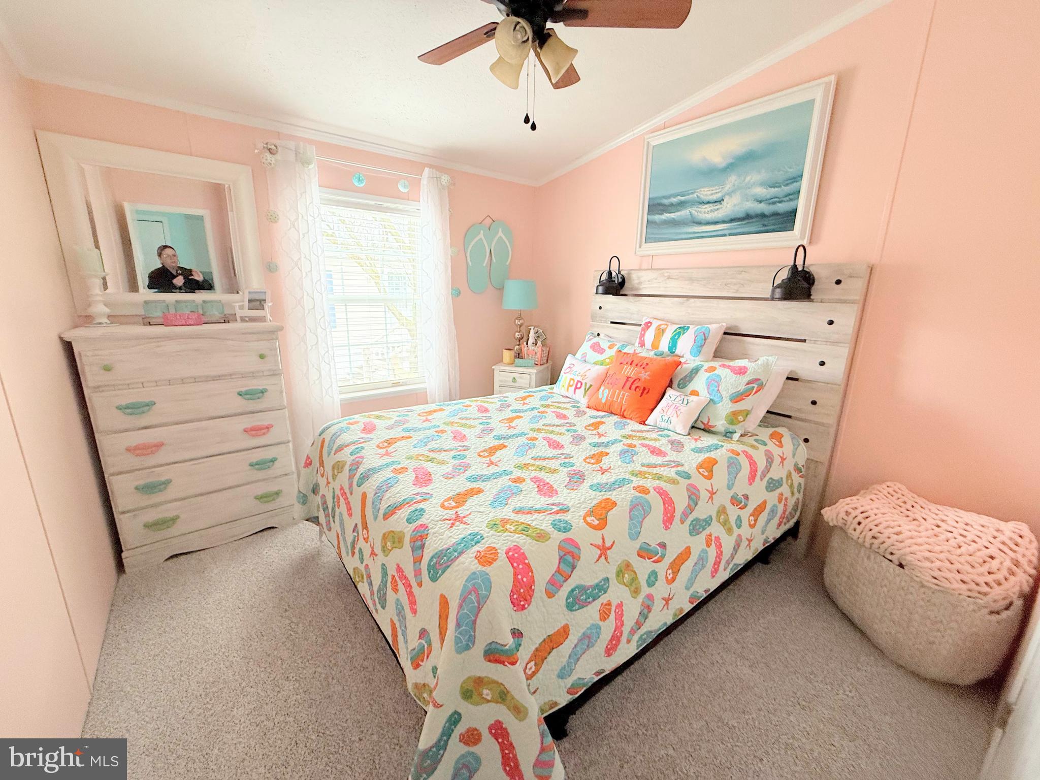 34488 Easy Street, Unit E810 Long Neck, DE 19966 - Photo 26 of 55 a bedroom with a bed and a chandelier