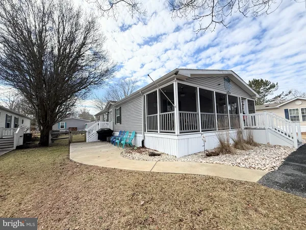 a view of a house with a yard covered in snow